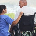Accessible Home Environment: Healthcare worker and man in wheelchair.